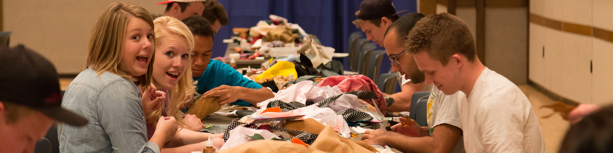 Students work at a table full of cloths