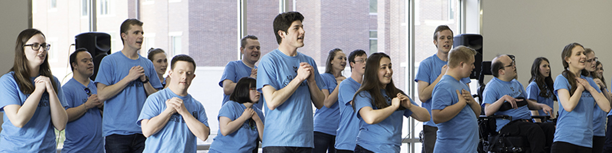 A group of BYU students and choir members dance during their concert.